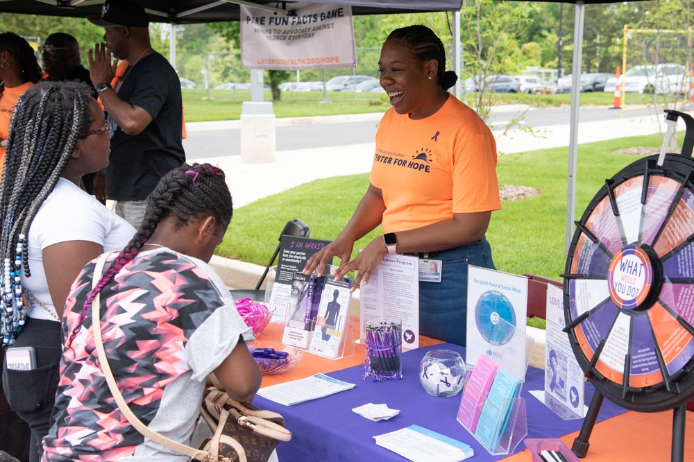 A Center For Hope employee talking to community members at an event